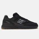 The Black 933 NAP New Balance Numeric Suede Skateboarding Shoes feature a white N logo, black laces, suede and mesh upper, and a gum rubber sole, displayed in side profile on a plain light background.