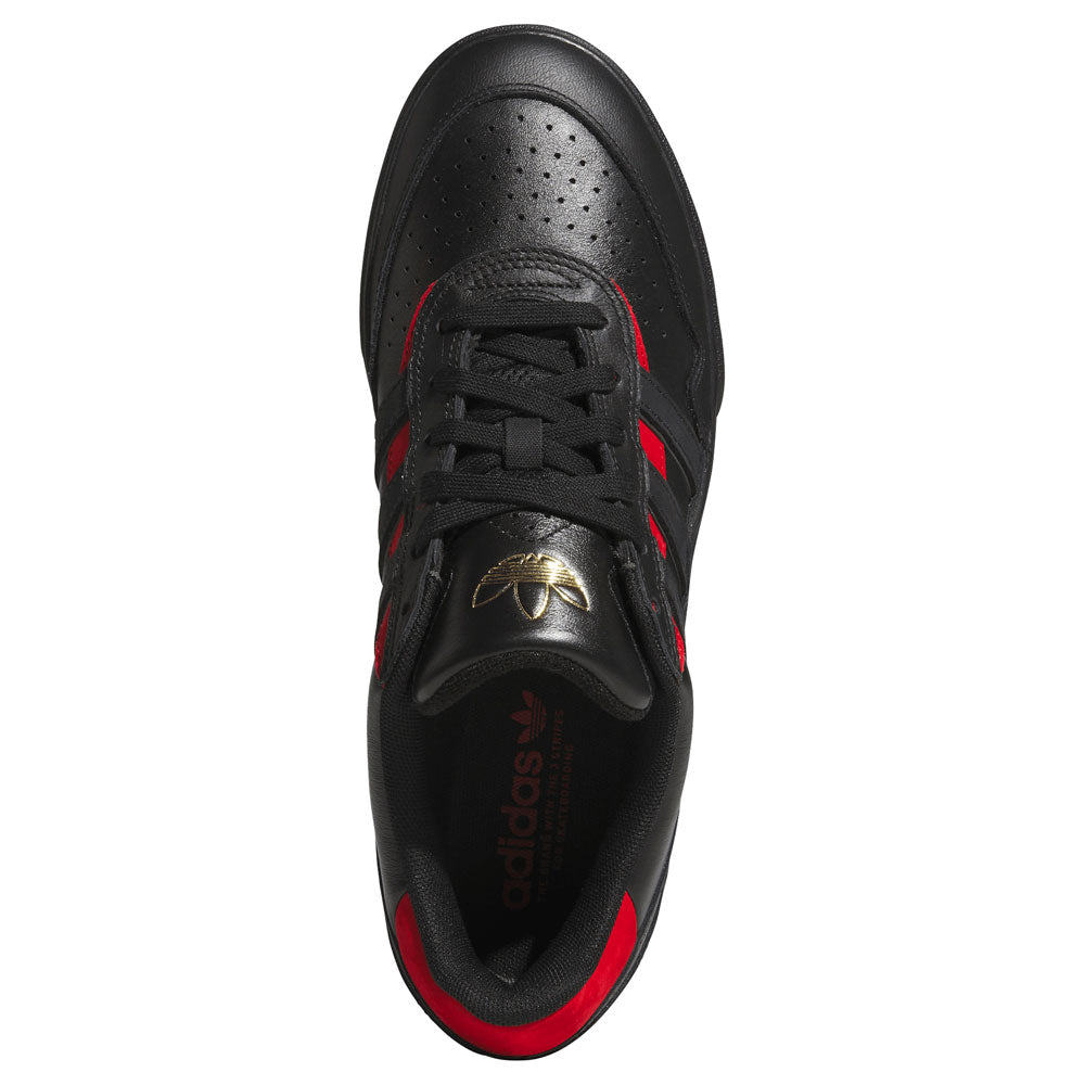 Top view of the Black Black KK2981 Tyshawn II Suede Adidas Skateboarding Shoe, featuring red stripes, black laces, and a gold adidas logo on the tongue. This sneaker showcases perforations on the toe and red accents on the inner lining, blending classic style with skate-ready performance.