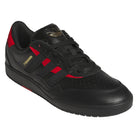 Introducing the Black Black KK2981 Tyshawn II Suede Adidas Skateboarding Shoes—a black athletic sneaker with red accents, black laces, a perforated toe, and gold ‘TYSHAWN’ text on the side. This adidas Originals style features the iconic gold Adidas logo on the tongue and delivers versatile performance as skateboarding shoes.