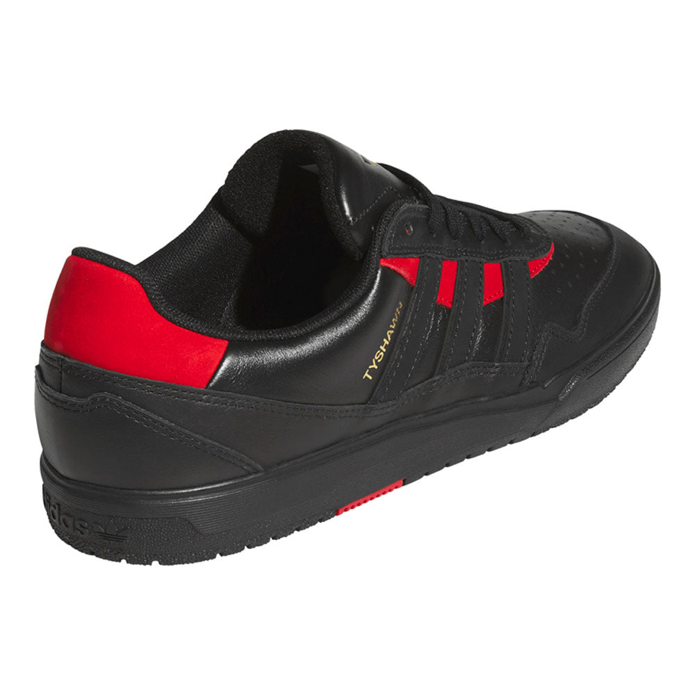 Black Black KK2981 Tyshawn II Suede Adidas Skateboarding Shoes by adidas are shown from an angle highlighting the outer side and back. This sneaker features a black suede upper with bold red accents on the heel and stripes, as well as “TOP SALA” written in gold on the side—echoing the iconic style of classic skateboarding shoes like the Tyshawn II.