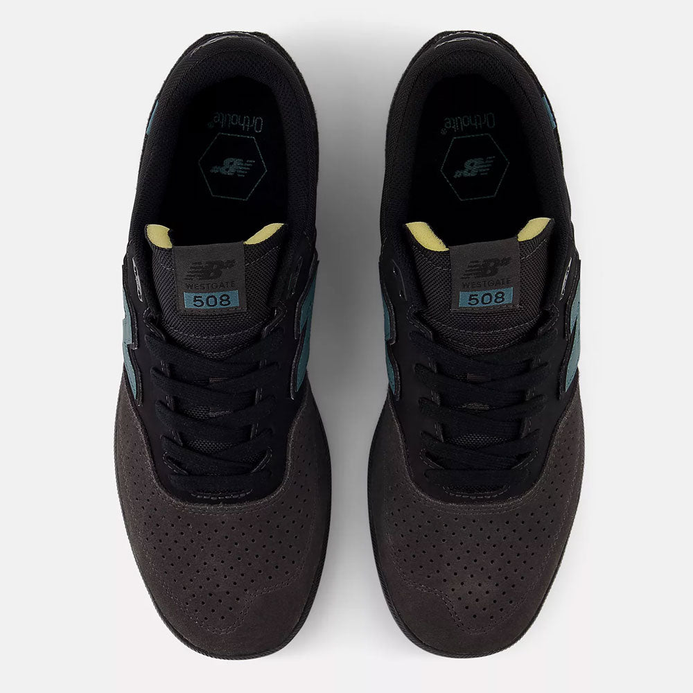 A top-down view of Black Cement New Spruce 508 TAC New Balance Numeric suede skateboarding shoes with light blue side logos, perforated toe boxes, and Ortholite insoles, set against a plain white background.