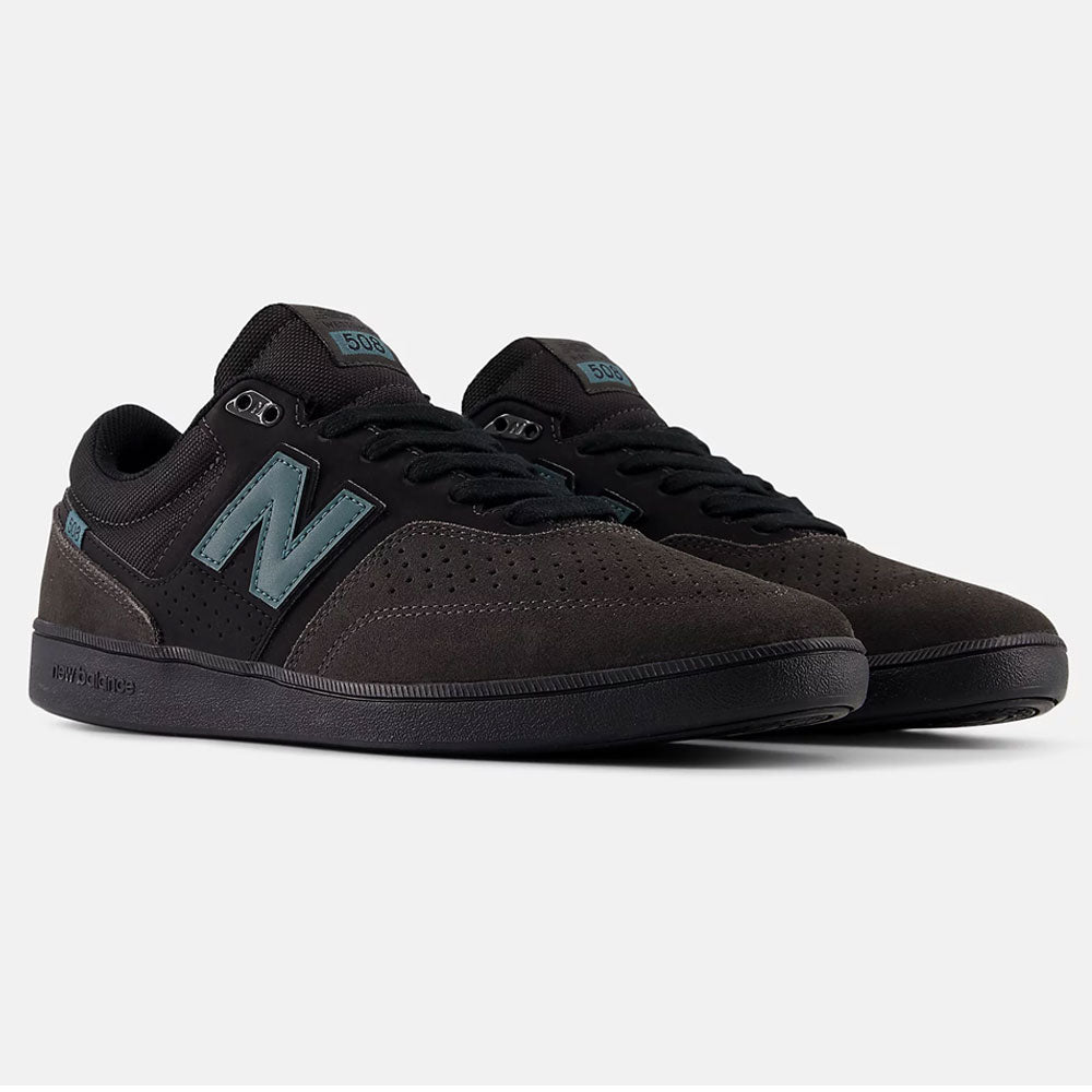 A pair of Black Cement New Spruce 508 TAC New Balance Numeric Suede Skateboarding Shoes with blue-gray N logos, black laces, and perforated toes, inspired by Brandon Westgate, side by side on a white background.