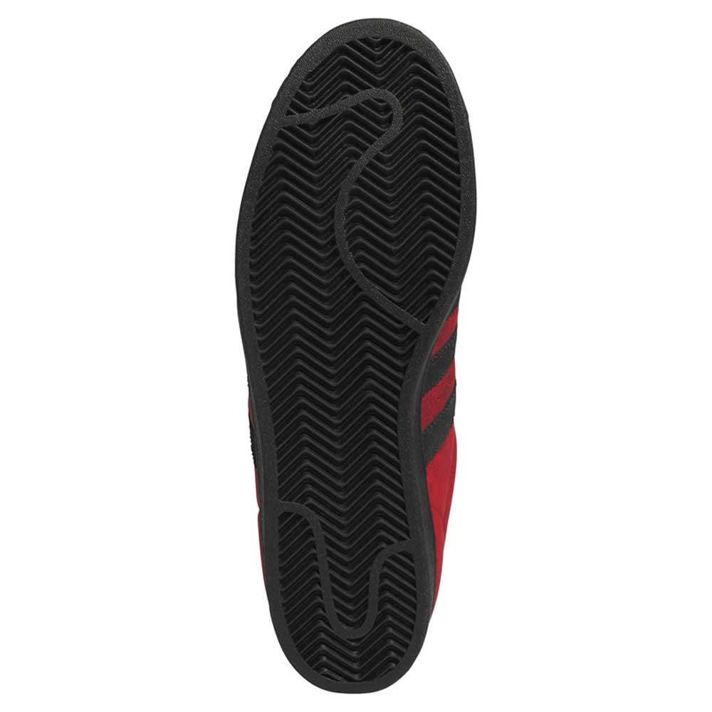 The image displays the bottom view of the Black Red Fog KJ5118 Superstar Adidas Skateboarding Suede Shoes Footwear, highlighting their black rubber sole with a herringbone tread pattern for enhanced grip—showcasing the reliable performance essential in skateboarding footwear.