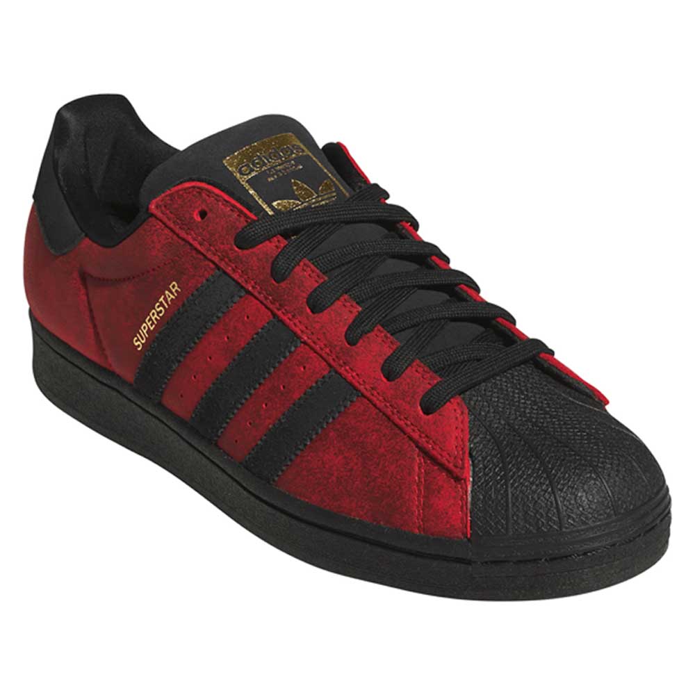 A pair of Black Red Fog KJ5118 Superstar Adidas Skateboarding Suede Shoes featuring a red and black colorway, black laces, a black sole, gold “SUPERSTAR” text on the side, and the iconic three black stripes—designed for classic skateboarding style.