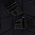 Close-up of two black plastic buckle clasps attached to black straps, positioned against a quilted black fabric background of the Black Reflect Silver IQ1279010 Nike SB RPM Skate Backpack.
