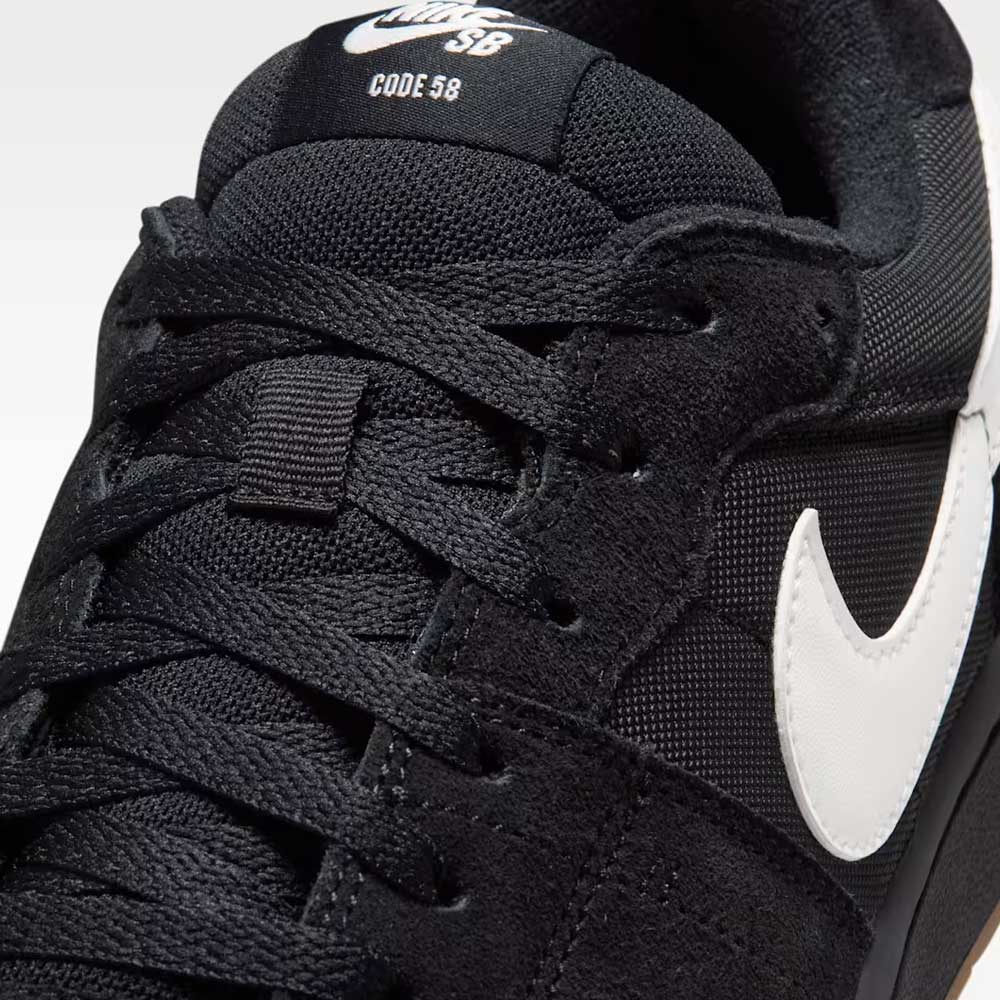 Close-up of the Black Summit White Code 58 IB0108001 Nike SB Skateboarding Suede Shoe, showcasing black laces, a white Nike Swoosh, and "Code 58" text on the tongue, with classic cupsole construction inspired by basketball-style sneakers.