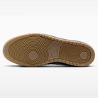 The bottom view of the Black Summit White Code 58 IB0108001 Nike SB Skateboarding Suede Shoes showcases a light brown gum sole with concentric circle tread patterns and the Nike SB logo embossed in the center, highlighting its classic cupsole construction inspired by basketball-style sneakers for superior support and durability.