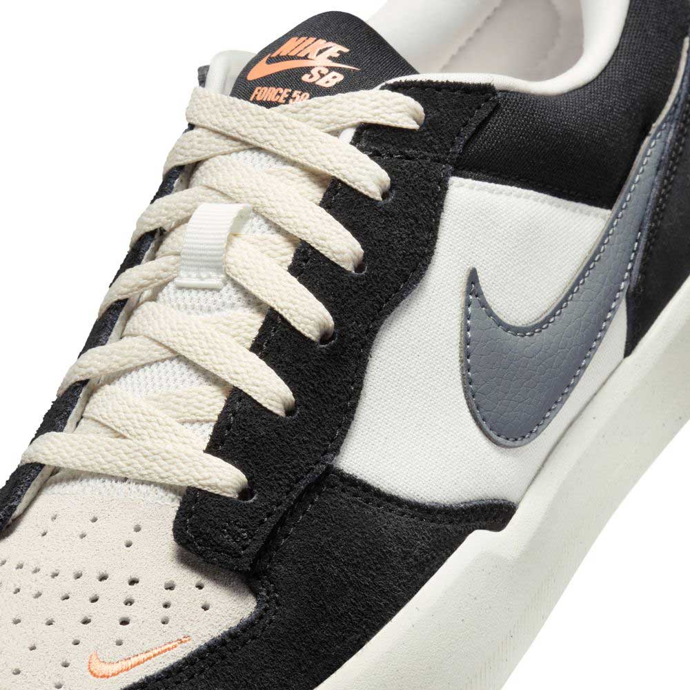 Close-up of the Black White DV5477-012 Force 58 Nike SB Suede Skateboarding Shoes, featuring a black and white upper, grey Swoosh, cream laces, perforated toe, and orange Nike branding on the tongue and toe area.
