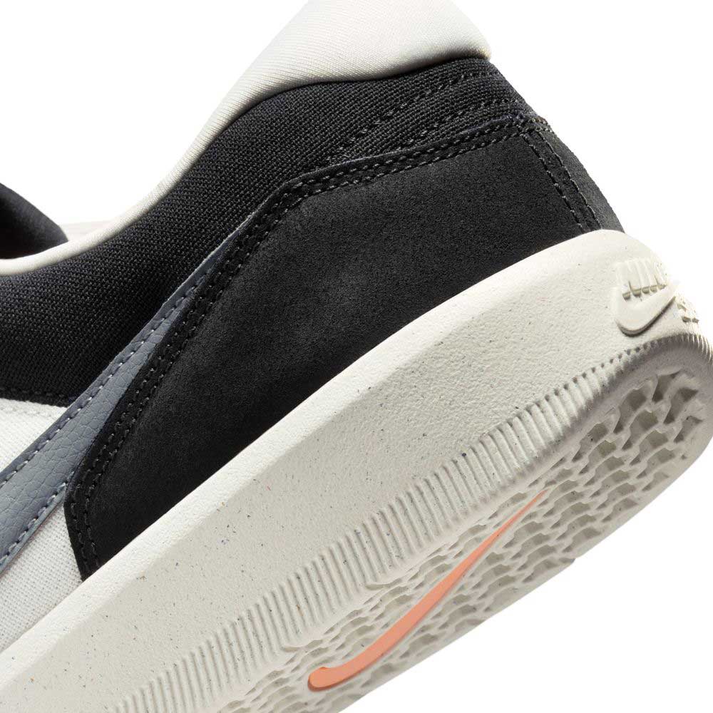 Close-up of the heel and sole of the Black White DV5477012 Force 58 Nike SB Suede Skateboarding Shoes, featuring black, white, and gray panels, a textured white midsole, an orange Swoosh, and embossed Nike logo blending heritage style.