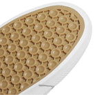 Close-up of the Black White Shmoofoil Slip RX HQ4720 Adidas Skateboarding suede shoe sole, showing a tan rubber honeycomb pattern with raised circles and a white border.