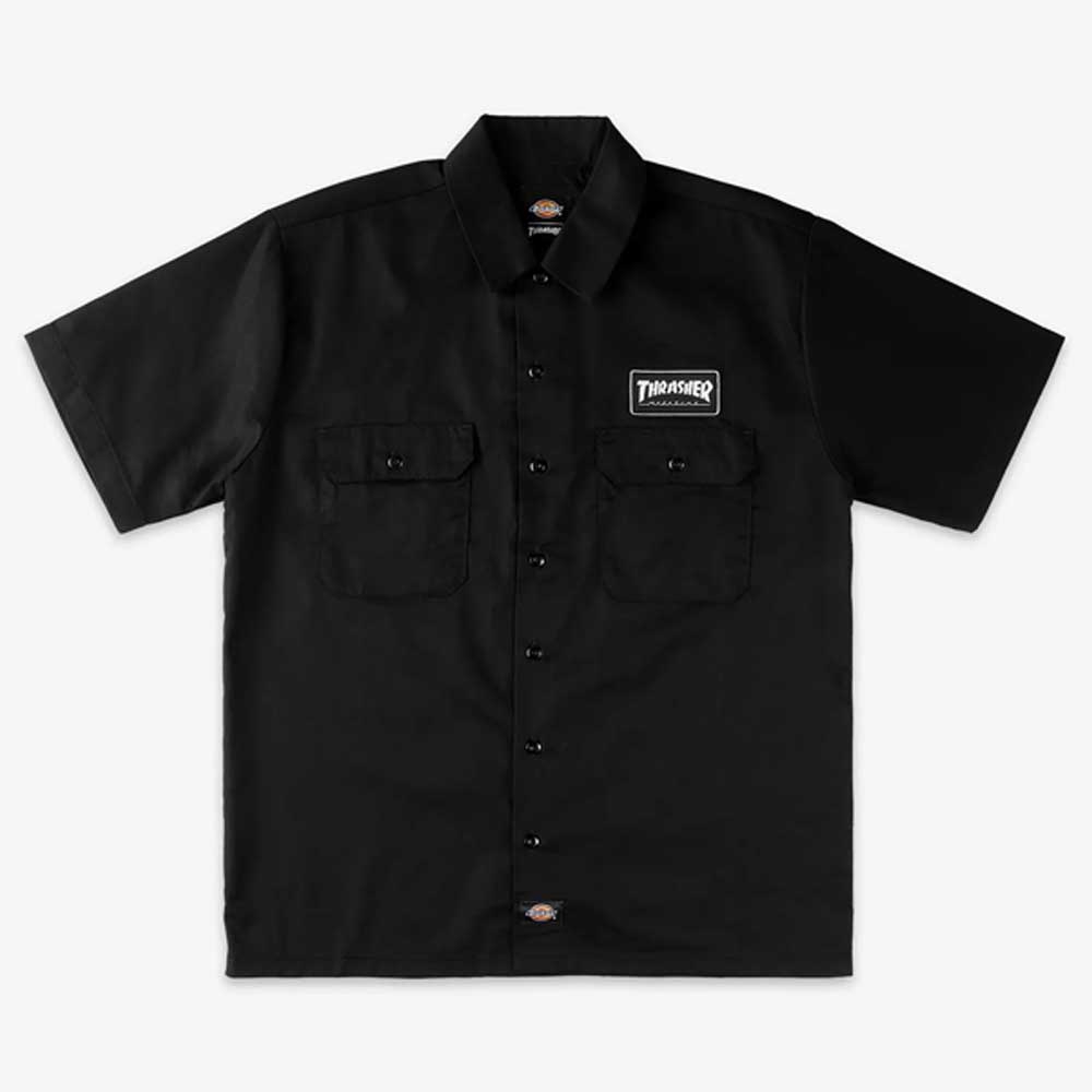 The Black Work Shirt Thrasher Magazine x Dickies Skateboarding A88HT BLK features a relaxed fit, short sleeves, dual chest pockets, a white Thrasher logo patch on the left pocket, and a small Dickies tag. Part of their exclusive skate collection.
