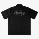 The Black Work Shirt Thrasher Magazine x Dickies Skateboarding A88HT BLK is a short-sleeve button-up with a collar, shown from the back, featuring a large outlined THRASHER logo across the upper back in a relaxed fit.