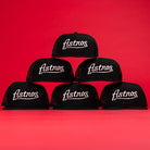 Six Black Scarlet Trucker Houston Cougars New Era 5950 Fitted Hats are arranged in a pyramid against a red background, showcasing bold school spirit and classic style for dedicated fans.