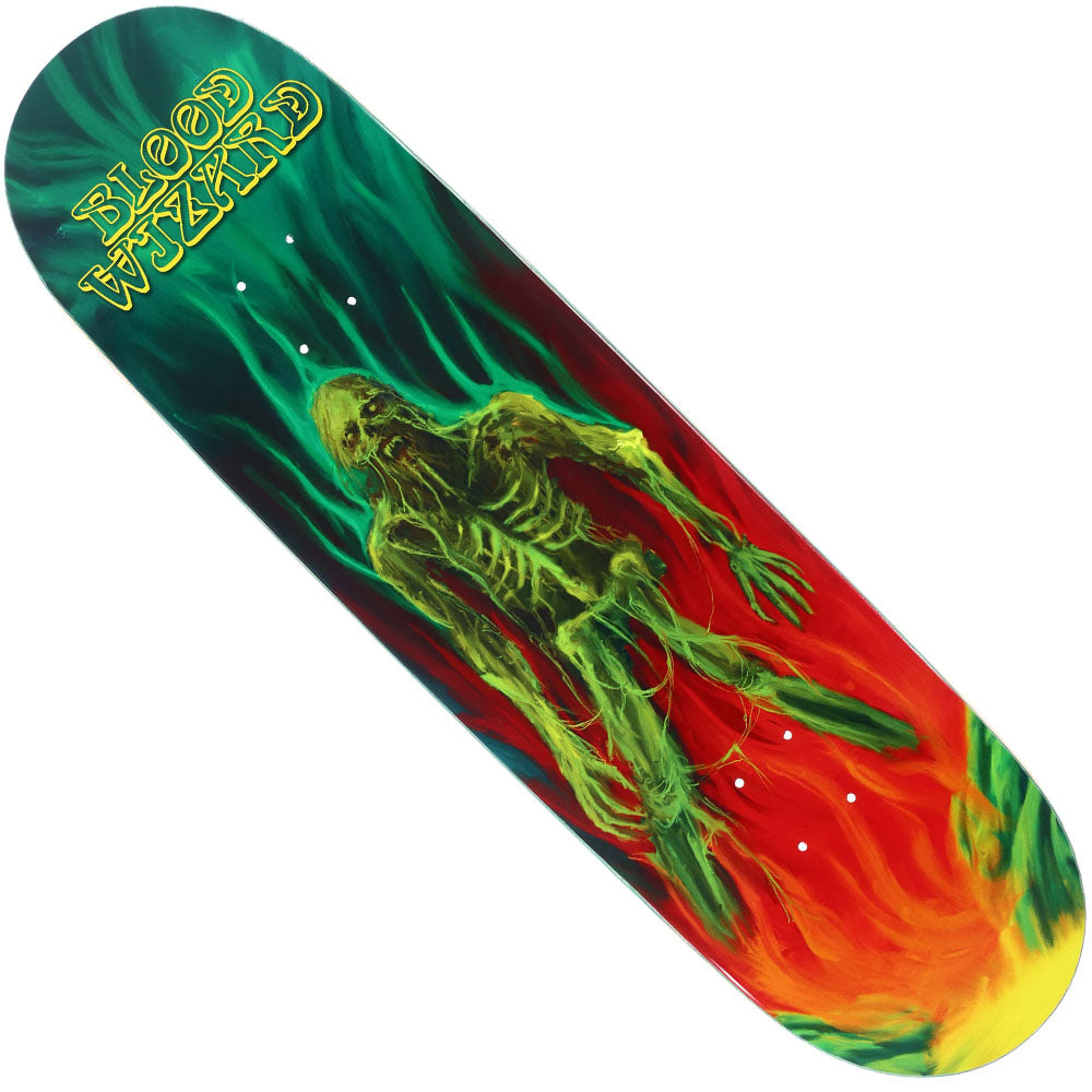 The Deathless 9x32.9 Deck by Blood Wizard Skateboards features a green skeleton zombie emerging from swirling red, orange, and green flames, with "BLOOD WIZARD" in bold yellow gothic font at the top left.