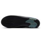 The image shows the black rubber outsole of the Blue Void Metallic Silver IR1887400 Air MAX Ishod Nike SB skateboarding shoes, featuring a wavy tread pattern and a blue-green heel accent that highlights its Max Air cushioning.