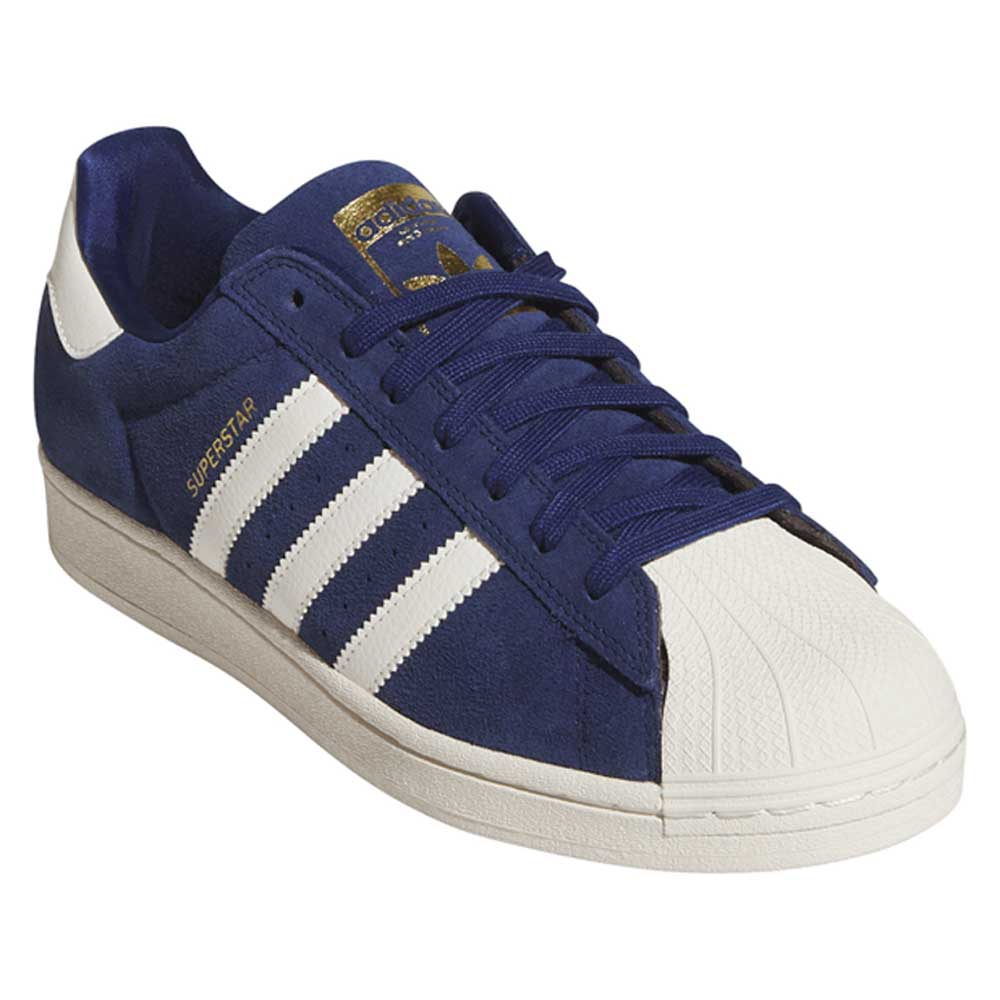 Introducing the Blue White KJ5113 Superstar Adidas Skateboarding Suede Shoes: this stylish sneaker features a blue suede upper with classic white stripes, a white heel tab, durable white rubber shell toe, and gold “Superstar” text on the side. The blue laces and tongue complete the iconic look, making these Adidas skate shoes both fashionable and built for performance.