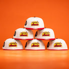 Six Poppa Burger Bo Bundy 35th Houston Astros Bo New Era Hat 5950 Fitted caps are stacked in a pyramid on an orange background, each featuring the bold team logo on the front.
