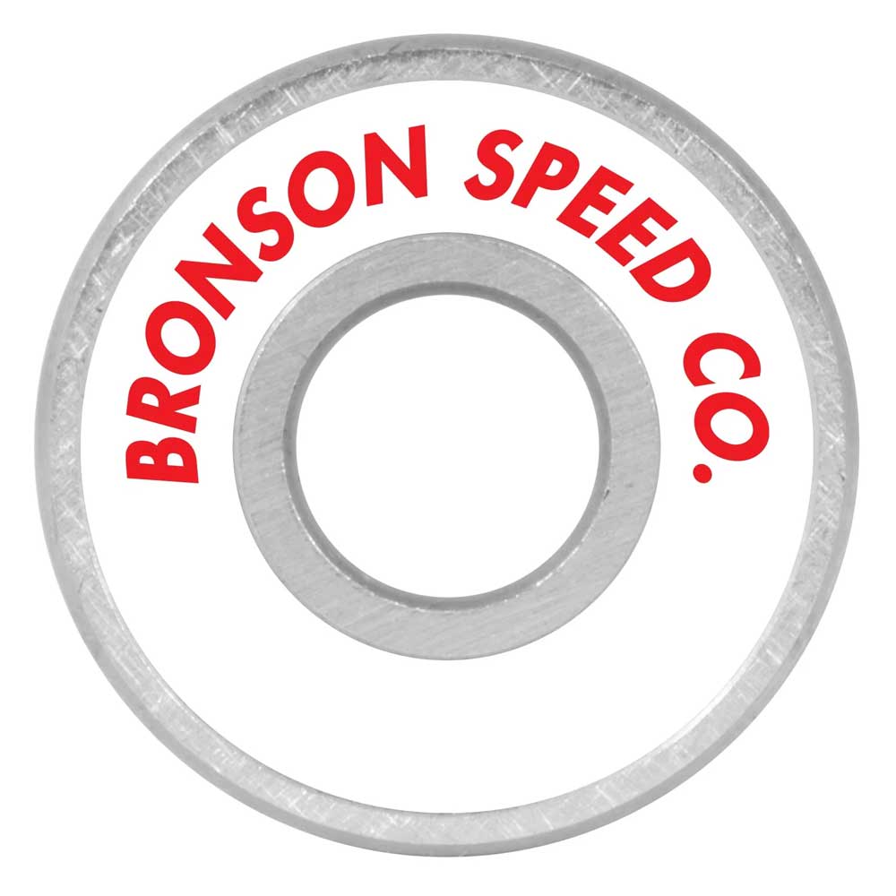 A close-up of a Bronson Speed Co. Skateboard Bearings Erick Winkowski Pro G3, with “BRONSON SPEED CO.” in bold red on the white surface and metallic outer and inner rings, as preferred by Erick Winkowski Pro.