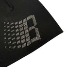 A close-up of the Bronze 56K x Ice Cream Rhinestone Beanie Black shows black fabric adorned with tiny white dots forming a 'B,' echoing the beanie's signature sparkling rhinestone detail.