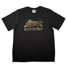 A Black Bronze 56K x Ice Cream Wunning Dog Tee featuring a graphic of a running dog above gold "BRONZE 56K" text on the front.