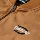 Close-up of the Brown Duck Vest Thrasher Magazine x Dickies Skateboarding A88IT 0BD, featuring a YKK zipper, Thrasher logo with a black stitched circular design, textured fabric, and a relaxed, street-ready fit.