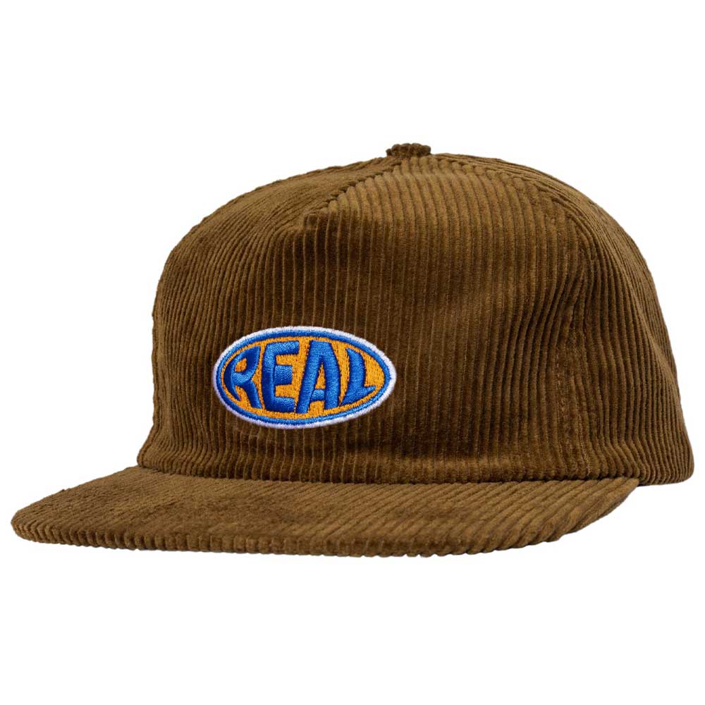 Bubble Oval Brown Real Skateboards Hat Adjustable—a brown corduroy baseball cap with a flat brim, featuring a blue and yellow Bubble Oval patch on the front that says "REAL" in bold letters; a classic from Real Skateboards.
