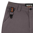 Close-up of Built to Grind Utility Shorts Pewter Bottom by Independent, showing a black and orange clip on the belt loop and a visible INDEPENDENT TRUCK CO. label on the waistband, emphasizing durable men's utility design.