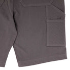 Close-up of the Built to Grind Utility Shorts Pewter Bottom Mens Independent, featuring gray fabric, two large flap pockets on the right leg, and visible seam details—designed for lasting durability.