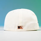 The Houstatlantavegas Chrome Black Green ASG Houston Astros New Era 5950 Fitted Hat is shown back-facing, with a rectangular MLB logo patch above the brim, set against a vibrant blue and green gradient background.