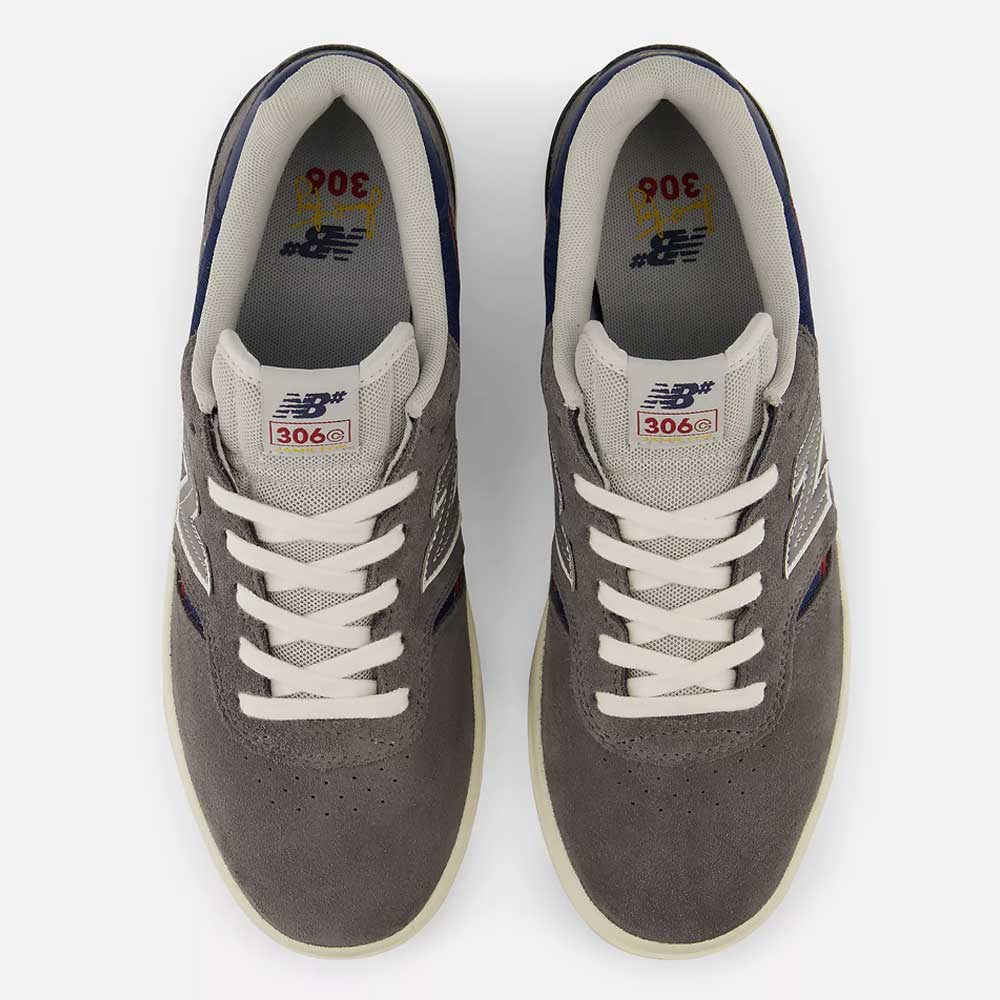Top view of a pair of Castlerock Navy Jamie Foy Cup 306 CYZ New Balance Numeric Suede Skateboarding Shoes, featuring a durable suede upper, white laces, white soles, and blue accents. The model number 306 is visible on the tongue of each shoe, delivering both impact protection and style.