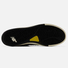 Castlerock Navy Jamie Foy Cup 306 CYZ New Balance Numeric Suede Skateboarding Shoes feature a black rubber outsole with white and yellow accents, showcasing the iconic New Balance logo and a textured grip pattern for superior impact protection—ideal for skateboarding.
