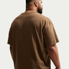 A man is shown from the back, standing against a plain light background, wearing the Nike SB Skateboarding Cell Phone Tee Brown IM4424235 T-Shirt.