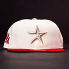 The Carter Chrome Scarlet Houston Cougars New Era Hat 5950 Fitted is a white baseball cap with a silver star emblem on the front and a bold red brim, showcased strikingly against a dark background.