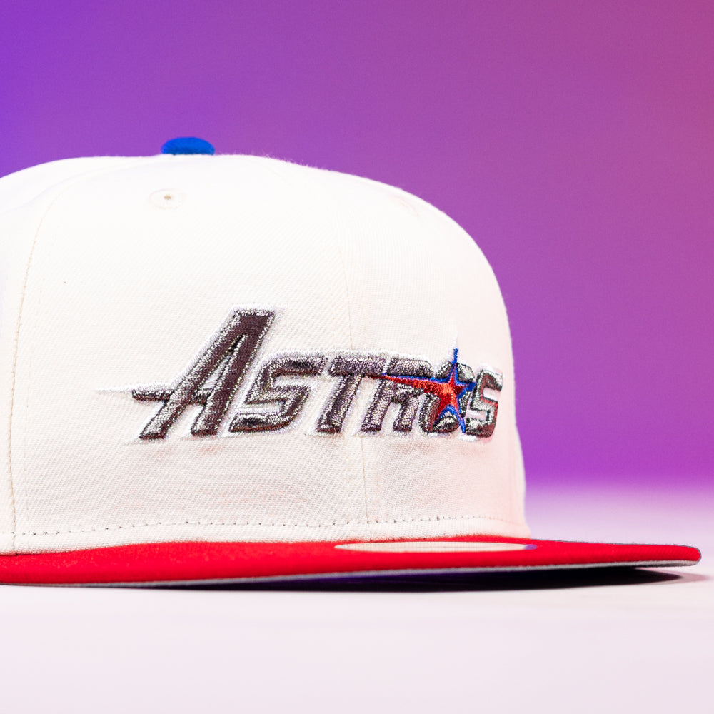 The Diplomat Chrome Scarlet Houston Astros New Era 5950 Fitted Hat is white with a red brim, blue button, and "Astros" embroidered in silver with a star, displayed on a purple gradient background.