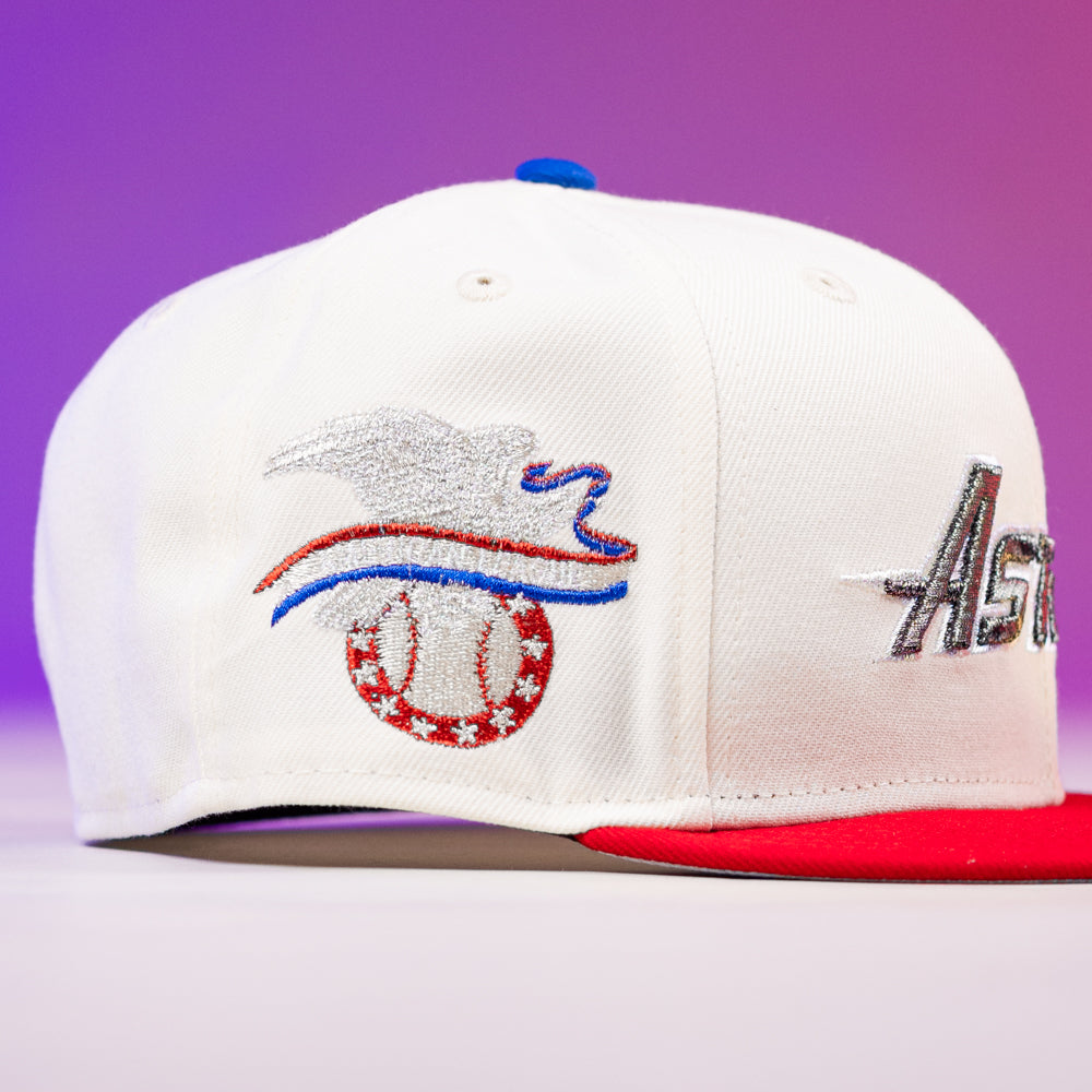 The Diplomat Chrome Scarlet Houston Astros 5950 Fitted New Era Hat is white with a red brim, features a stylized eagle baseball embroidery in silver and blue, metallic "Astros" accents, and a purple-pink gradient background.