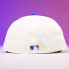 A Diplomat Chrome Scarlet Houston Astros New Era 5950 Fitted Hat in white, shown from the back with a small embroidered MLB logo above the brim, set against a purple-to-pink gradient background.