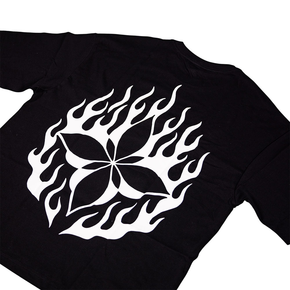 The Cleo Flame Black Tee is a black cut-n-sew T-shirt from the Cleo tees collection, featuring a bold white graphic on the back—a stylized four-petal flower encircled by flame-inspired shapes—for an artistic statement in every detail.