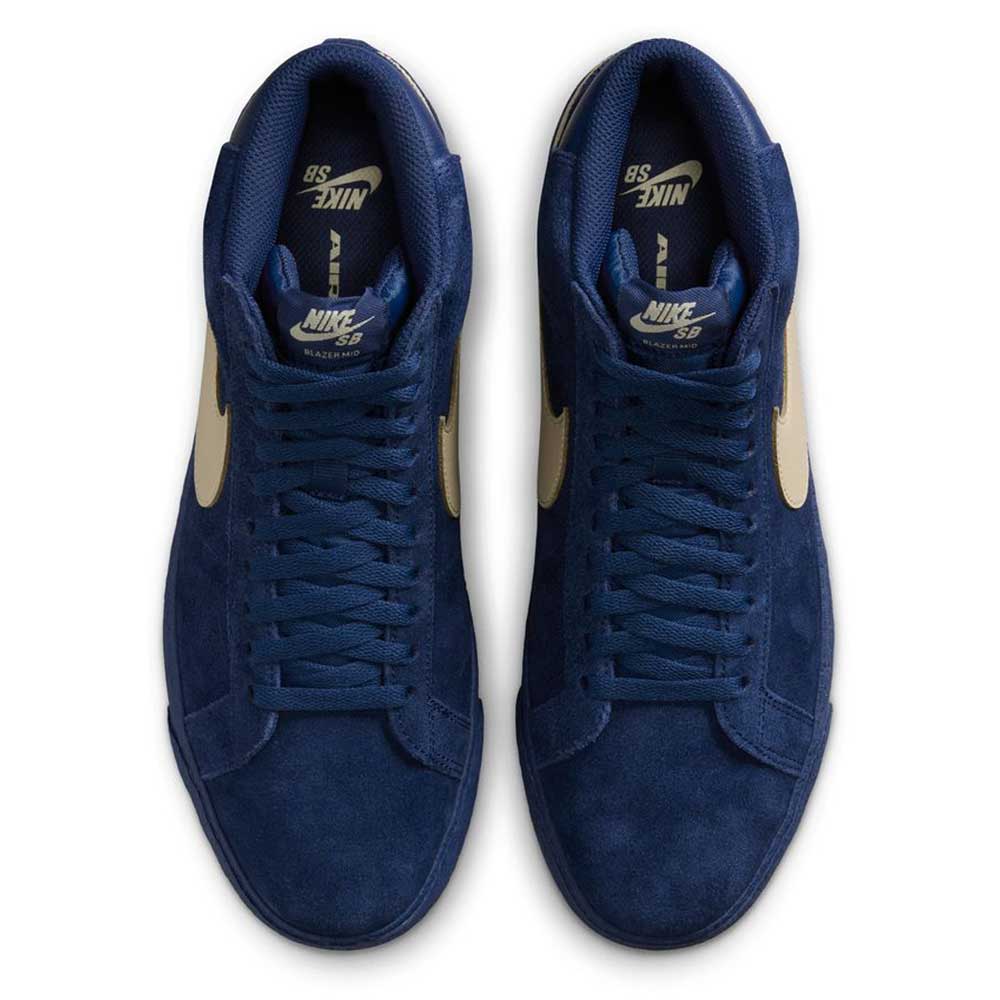 A pair of Coastal Blue Pale Yellow IO0667400 Blazer Mid Nike SB Suede Skateboarding Shoes with blue laces, cream swooshes, responsive cushioning, and visible Nike SB logo on the insoles, viewed from above.