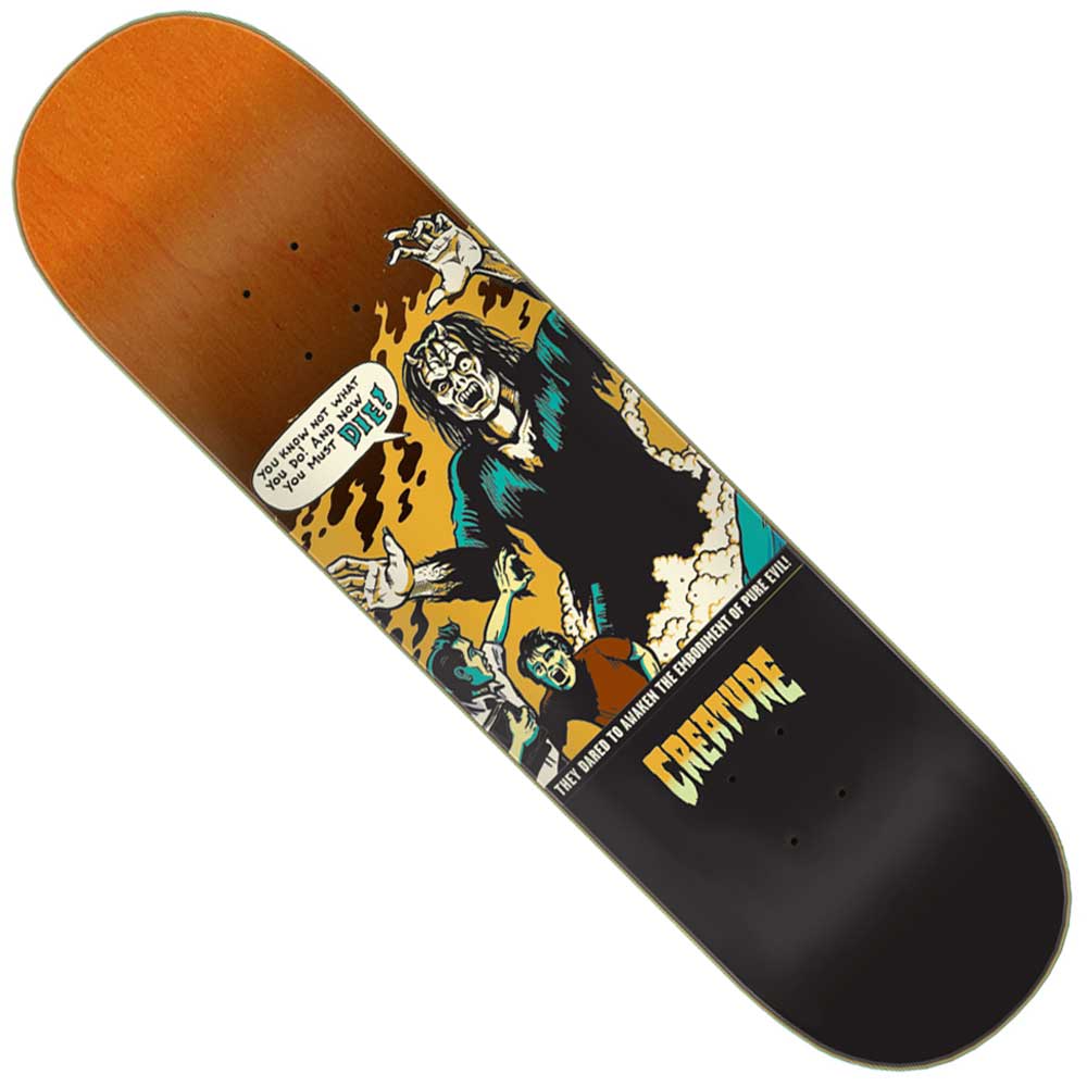 The Creature Comicbook Relic Stumps Deck is an 8.25in x 31.80in 7 Ply Birch skateboard featuring cartoon zombies—one with a "You have to be alive to be dead" sign—and bold yellow "Creature" lettering.