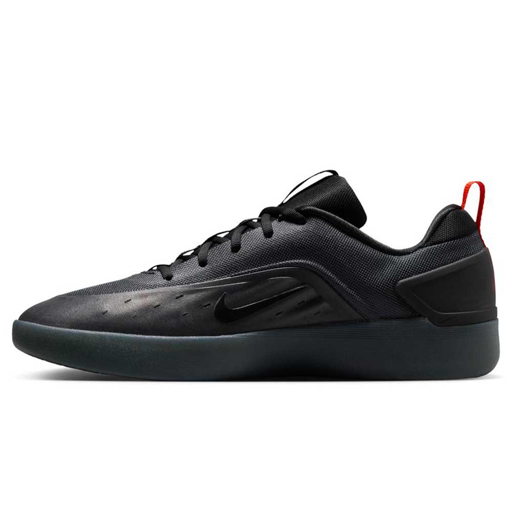 Side view of the Cool Grey White FQ1273003 Zoom Nyjah 4 Nike SB Skateboarding Shoe, featuring a reinforced mesh upper, black swoosh, black laces, dark sole, and a red heel pull tab against a white background.