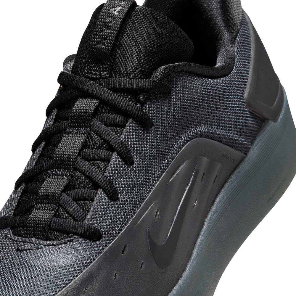 Close-up of the Cool Grey White FQ1273003 Zoom Nyjah 4 Nike SB Skateboarding Shoe, featuring a reinforced mesh upper, black laces, a glossy black Nike swoosh on the side, and a sleek, modern design with a dark, thick sole.