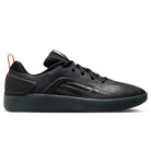 The Cool Grey White FQ1273-003 Zoom Nyjah 4 Nike SB Skateboarding Shoes feature a sleek black design with a subtle swoosh, black laces, red heel pull tab, reinforced mesh upper, Air Zoom cushioning, and a thick dark sole for sporty comfort.
