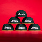Five El Tuga Houston Astros New Era 5950 Fitted hats in green, each with the team logo, are displayed in a pyramid shape on a vivid red background.