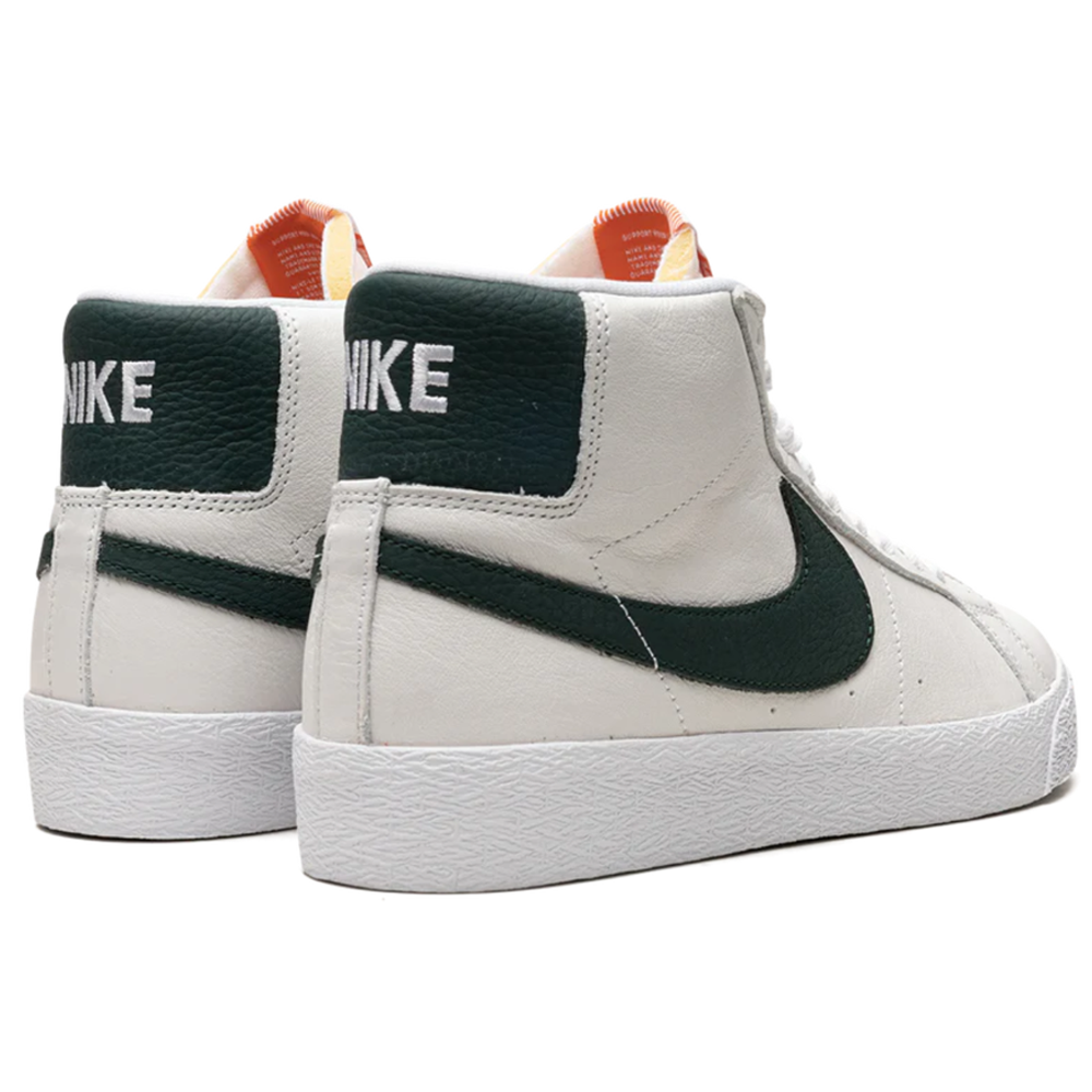 A pair of DR9092-100 White Pro Green Blazer Mid Nike SB leather skateboarding shoes, featuring dark green swooshes and NIKE text on the heels, displayed on a white background.