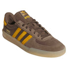 Introducing the Daewon Song Glenburn Brown Yellow KZ8777 Adidas Skateboarding Shoes: these brown Adidas sneakers feature bold yellow stripes, a yellow heel accent, and yellow branding on the tongue. The unique translucent sole and “DAEWON” printed above it give these trainers a signature edge. Crafted with a mix of suede and mesh materials, these shoes are ideal for anyone who loves skate-inspired footwear with striking street style elements.