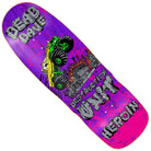 The Dead Dave Knock Off 10.1x32.1 Heroin Deck Shaped Various Stains Skateboard features a vivid purple design, bold “DEAD DAVE,” “DESTRUCTION UNIT,” and “HEROIN” text, plus a green monster truck crushing a burning building graphic.