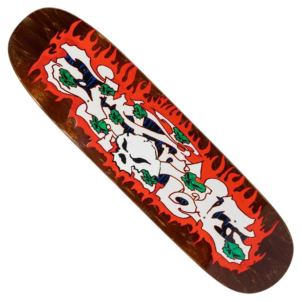 The Depths Marbie 8.5 There Skateboards Deck features red flame edge graphics, white graffiti text in the center, green leaves, and a skull on a brown wood background.
