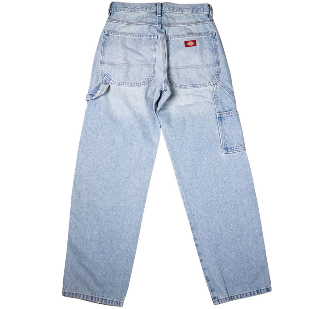 The Worn In Lightweight RI2 A89G7 Retro Indigo Men's Woven Dickies Skateboarding jeans feature light blue denim, two large back pockets, a red and yellow Dickies logo patch, and a utility loop on the right leg.