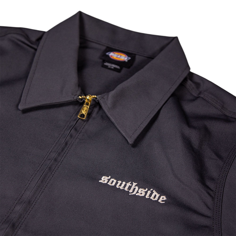 A close-up of the Charcoal Silver Embroidered Old English Black Southside Dickies Unlined Eisenhower Jacket shows "southside" in white Old English on the left chest and a Dickies label inside the collar. This industrial-wash friendly jacket features a zip-up front.