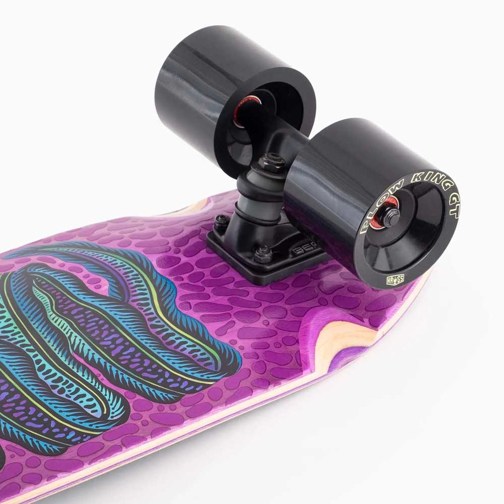 Close-up of a Dinghy Classic Fender Moray Eel Landyachtz skateboard’s rear end with black trucks and 74mm wheels. The textured purple deck displays green and blue wavy graphics, and "NEW KING GT" appears on the wheel’s side.